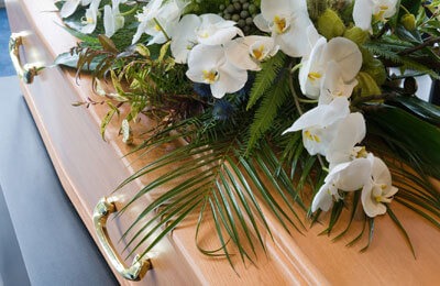 coffin with flowers on top